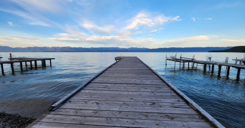 Three piers on Flathead Lake facing the mountains at sunset