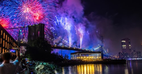 USA, New York, July: Fireworks during the celebration independence day in the USA. People are watching fireworks nearby Brooklyn bridge