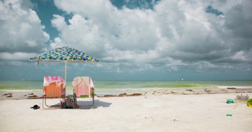 A pair of deck chairs overlooking the water at Honeymoon Beach State Park in Florida.
