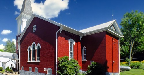 A small red church on main street in Mifflinburg, Pennsylvania