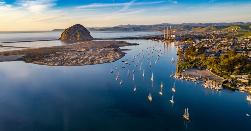 An aerial view of Morro Bay, California, with numerous boats in the water.