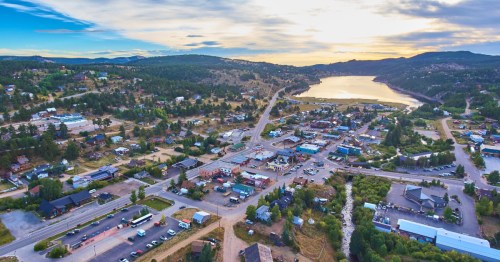 An aerial view of the small town of Nederland, Colorado, with Baker Reservoir in the distance.