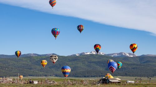 Hot air balloons fly through the sky in New Mexico