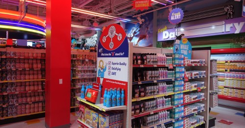 A staged grocery store setting with strange items from Omega Mart in Las Vegas.