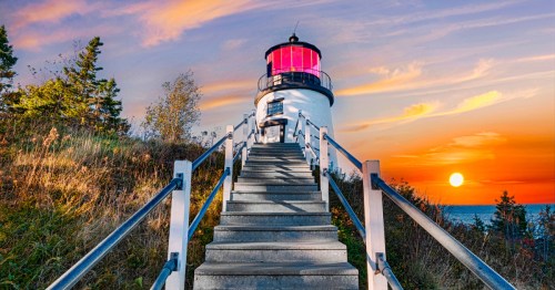 A view up the stairs of the Owl's Head lighthouse in Maine at sunset.