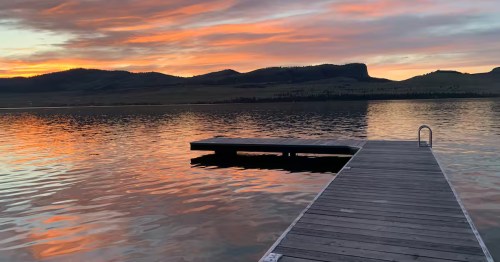 A fiery sunset over a private dock at a Montana lake.