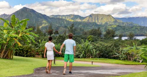 Two young people relaxing in Hanalei Bay resort in Kauai.
