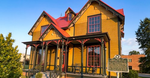 A close-up of the yellow-and-red Tennessee Williams House in Columbus, Mississippi.
