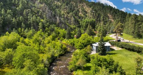 A house along a river in the Black Hills of South Dakota