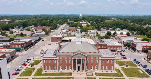 Aerial view of downtown Independence, Missouri, featuring the Historic Truman Courthouse and surrounding square.
