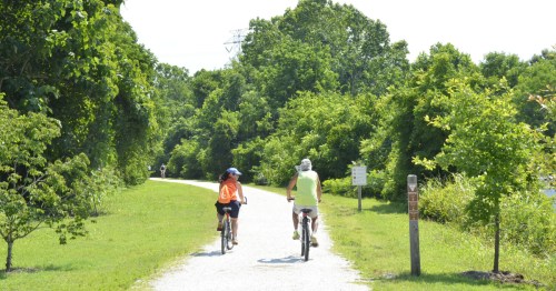 Two bikers along High Bridge Trail in Farmville, Virginia, on a summer day.