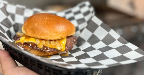 Cheesy smash burger with grilled onions in a basket at Smash Buddies in Columbus Ohio.