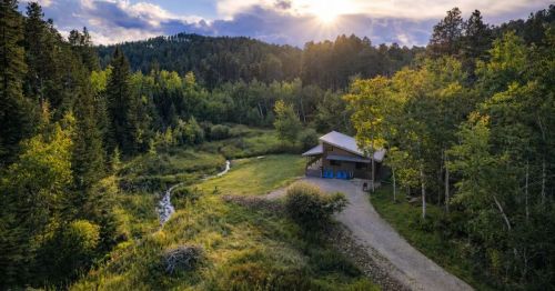 A cabin next to a creek in the Black Hills of South Dakota