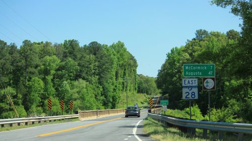 Highway next to a green sign that says "McCormick 7" under a blue sky.