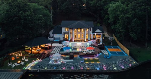 aerial shot of a luxury garland county arkansas home with a pool, dome, outdoor seating, etc. on the water