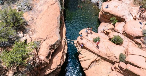 Aerial views of a hidden swimming hole in Arizona, surrounded by red rock canyons.