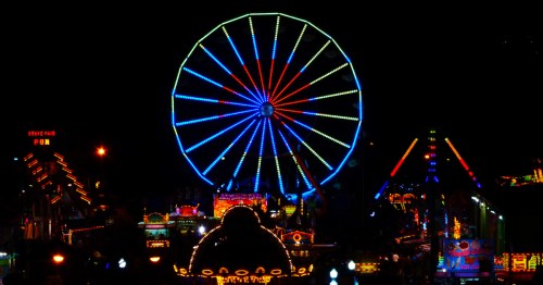 amusement rides aglow with LED lights at night at the indiana state fair