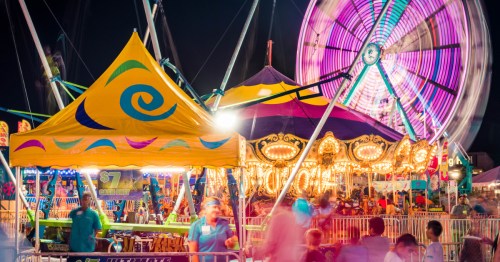 amusement rides aglow at night at the kentucky state fair