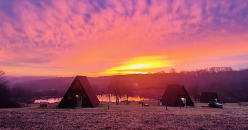 White Oak Cabins in Southern Illinois at sunset with a lake in the background
