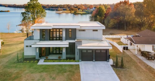 Two-story luxury lakefront home with large windows in Nashville Tennessee