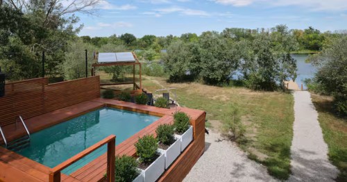 Private deck swimming pool overlooking a scenic path to the lake in Pleasanton, KS.