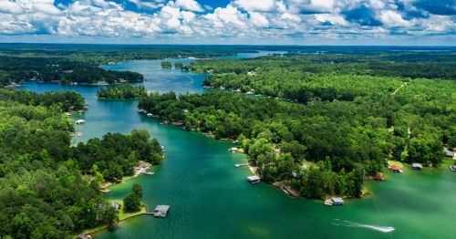 Aerial views of Lake Martin in Alabama, featuring lakefront homes surrounded by greenery.