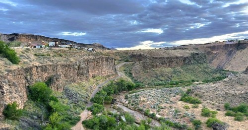 Views of a cliffside hotel in the town of La Verkin, Utah, with a river below.