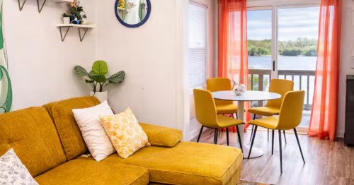 Spring River Escape treehouse living room looking out onto the water in Moline, Illinois