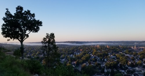 Scenic twilight view of Lancaster Ohio with low morning fog covering the valley town.