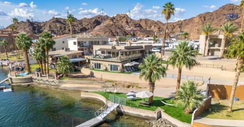 aerial shot of a luxury home with a private beach and dock on the colorado river in parker arizona