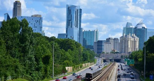 Atlanta skyline and public transit on the highway.