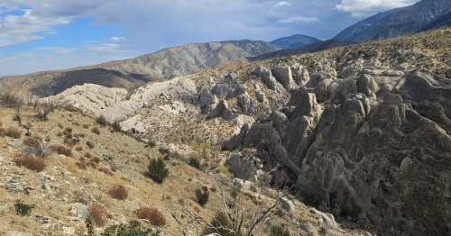A large canyon with unique rock formations as seen from the Devils Punchbowl Loop Trail in California.