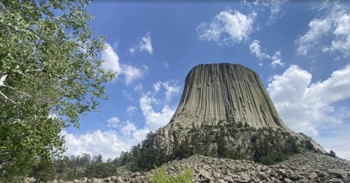 Devils Tower surrounded by clouds in Wyoming.