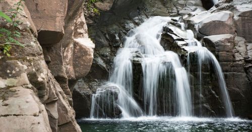 Waterfall at Fawn's Leap in the Catskill Mountains, and there's a beautiful waterfall flowing over rocks and pouring into a swimming hole.
