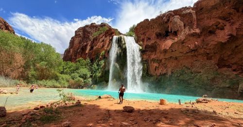 The red-rock cliffs and sparkling turquoise swimming hole at Havasu Falls in Arizona—one of the most famous hidden swimming holes across the U.S.