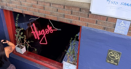 A basement staircase leading down into Hugo's in Fayetteville.