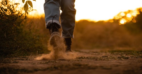 Someone walking in hiking boots at dusk, a scene from a seeminlgy scary hiking trail in Iowa, the T-bone Trail near Audubon.