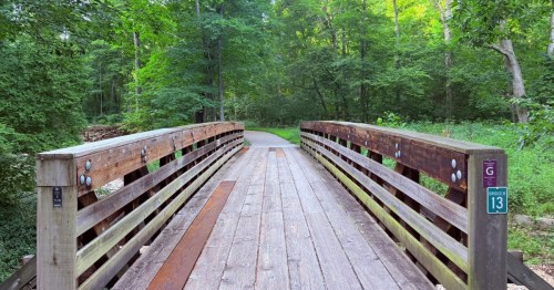 A an old bridge leading to a hiking path in the woods on Zombie Trail aka Rock Hollow Trail in Missouri.