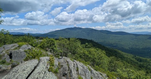 A view of the surrounding mountains from a rocky overlook on Rattlesnake Mountain, New Hampshire.