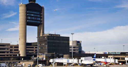 air traffic control tower overlooks the tarmac at Logan International Airport (BOS) in Boston, MA
