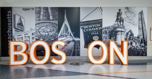 a sign for Boston where travelers can take photos in a concourse at boston logan international airport in massachusetts
