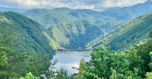 Elevated view of Calderwood Lake in East Tennessee, surrounded by blue and green mountains.