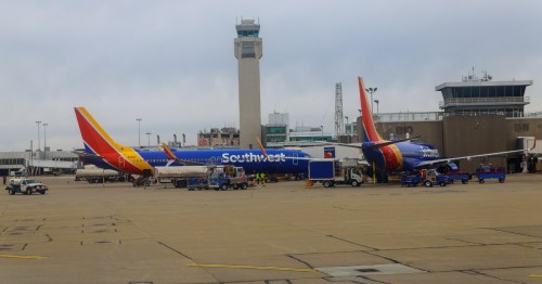 southwest airlines planes at terminal gates near an air traffic control tower at Cleveland Hopkins International Airport (CLE) in ohio