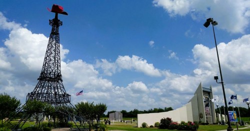 Views of a replica of the Eiffel Tower in Paris, Texas, with a large red cowboy hat on top.