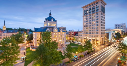 Lexington, Kentucky, courthouse surrounded by downtown buildings at dusk