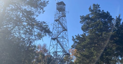 A fire tower rises up from the trees in South Carolina.