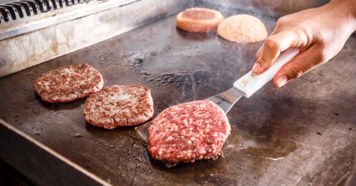 burgers on a restaurant grill