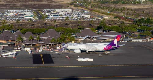 a hawaiian airlines a330 plane parked at a gate at the Ellison Onizuka Kona International Airport (KOA) on the Big Island, Hawaii