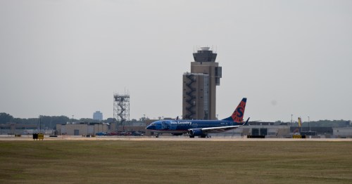 sun country plane on the runway in front of the air traffic control tower at Minneapolis-Saint Paul International Airport (MSP) in Minnesota