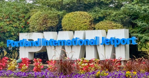 entry sign for portland international jetway (PWM) surrounded by colorful floral landscaping in maine